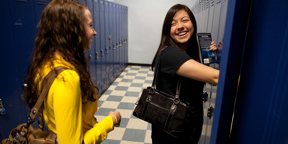 Students share a laugh between classes at Carrick High School.